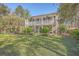 Charming two-story home with a double front porch and lush landscaping at 4462 Francis Yonge Way, Hollywood, SC 29449