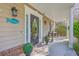 Charming front porch featuring classic lanterns, a 'Welcome' mat and decorative greenery at 4462 Francis Yonge Way, Hollywood, SC 29449