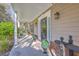 Charming front porch with decorative plants, a welcoming mat, and exterior lighting at 4462 Francis Yonge Way, Hollywood, SC 29449
