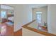 Upstairs hallway with hardwood floors leads to a bedroom and access to a balcony at 4462 Francis Yonge Way, Hollywood, SC 29449
