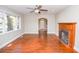 Spacious living room featuring hardwood floors, a fireplace, and large windows at 5468 W Lakeland Dr, North Charleston, SC 29406