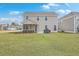 Backyard featuring a screened-in porch, barbecue, and lush green lawn at 667 Black Pine Rd, Moncks Corner, SC 29461