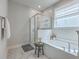 Bright bathroom featuring a soaking tub, glass-enclosed shower, and white subway tile at 667 Black Pine Rd, Moncks Corner, SC 29461