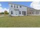 A spacious backyard features a screened-in porch, providing a perfect transition from indoor to outdoor living at 707 Alma Square Dr, Moncks Corner, SC 29461