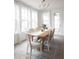 Elegant dining room with a wooden table, white chairs, and natural light at 707 Alma Square Dr, Moncks Corner, SC 29461