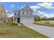 Charming two-story home with a well-manicured lawn and a two-car garage at 707 Alma Square Dr, Moncks Corner, SC 29461