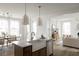 Open concept kitchen with a large island, stainless steel appliances, and adjacent dining area at 707 Alma Square Dr, Moncks Corner, SC 29461