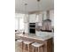 Bright kitchen featuring an island with seating, white cabinets, and modern appliances at 707 Alma Square Dr, Moncks Corner, SC 29461