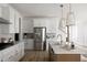 Modern kitchen with white cabinets, stainless steel appliances, and a functional island at 707 Alma Square Dr, Moncks Corner, SC 29461