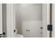 Bright, minimalist powder room features a white toilet, towel bar, and door at 709 Oakridge View Trl, Ridgeville, SC 29472