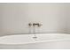 Close up of freestanding white soaking tub complemented by sleek, modern fixtures at 709 Oakridge View Trl, Ridgeville, SC 29472