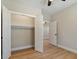 Bedroom features hardwood floors, a closet, and a hallway leading to the home's interior at 709 Oakridge View Trl, Ridgeville, SC 29472