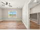 Bedroom boasts a ceiling fan, a window and hardwood floors, and a walk-in closet at 709 Oakridge View Trl, Ridgeville, SC 29472