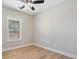 Light bedroom with hardwood floors, large window, and ceiling fan at 709 Oakridge View Trl, Ridgeville, SC 29472