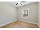 Light bedroom with hardwood floors, large window, and ceiling fan at 709 Oakridge View Trl, Ridgeville, SC 29472