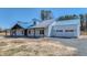 Beautiful exterior view of a modern farmhouse with a metal roof and covered front porch at 709 Oakridge View Trl, Ridgeville, SC 29472