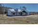 Charming single-story home featuring a light blue metal roof and a welcoming covered porch at 709 Oakridge View Trl, Ridgeville, SC 29472