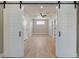 Open view with barn doors to a hallway with a ceiling fan and white doors at 709 Oakridge View Trl, Ridgeville, SC 29472