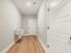 Hallway featuring utility sink and wood-look floors at 709 Oakridge View Trl, Ridgeville, SC 29472