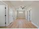 Hallway with multiple white doors and light-colored wood flooring at 709 Oakridge View Trl, Ridgeville, SC 29472
