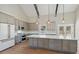 Spacious kitchen with gray cabinets, a large island, stainless appliances, and wood flooring at 709 Oakridge View Trl, Ridgeville, SC 29472
