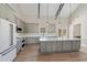 Spacious kitchen with gray cabinets, a large island, stainless appliances, and wood flooring at 709 Oakridge View Trl, Ridgeville, SC 29472