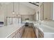 Bright kitchen with gray cabinets, large island, stainless appliances, and high ceiling with modern pendant lights at 709 Oakridge View Trl, Ridgeville, SC 29472