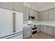 This kitchen has stainless appliances, light gray cabinets, a double oven, and quartz countertops at 709 Oakridge View Trl, Ridgeville, SC 29472
