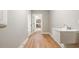 Bright mudroom with hardwood floors, laundry sink, and view into the kitchen at 709 Oakridge View Trl, Ridgeville, SC 29472