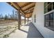 Exterior shot of the house featuring a long covered porch with ceiling fans at 709 Oakridge View Trl, Ridgeville, SC 29472