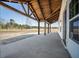 Inviting porch with ceiling fan and wooden support beams at 709 Oakridge View Trl, Ridgeville, SC 29472