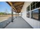 Exterior featuring a long covered porch with wooden beams and ceiling fans at 709 Oakridge View Trl, Ridgeville, SC 29472