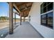 Long, inviting porch with exposed wood beams and a view of the natural surroundings at 709 Oakridge View Trl, Ridgeville, SC 29472