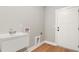 Utility sink in hallway with wood-look floors at 709 Oakridge View Trl, Ridgeville, SC 29472