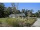 A well-maintained pool house is landscaped with native plants and grass at 749 Jancus St, Charleston, SC 29414