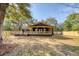 View of house exterior from backyard, featuring the stained wood fence, back deck, and covered porch at 841 Fred St, Charleston, SC 29412