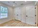 Bright bedroom featuring hardwood floors, ceiling fan, natural light, and a double door closet at 841 Fred St, Charleston, SC 29412