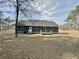 Rear of home featuring blue siding, wooden deck, and large backyard at 85 Prestwick Pl, Walterboro, SC 29488