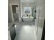 Bright bathroom featuring a freestanding tub under a window and tiled floors at 85 Prestwick Pl, Walterboro, SC 29488