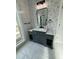 Modern bathroom with floral wallpaper, black fixtures, and a marble-topped vanity at 85 Prestwick Pl, Walterboro, SC 29488