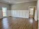 Bedroom with decorative wainscoting, hardwood floors and view into the bathroom at 85 Prestwick Pl, Walterboro, SC 29488
