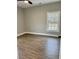 Well-lit bedroom featuring wood-look floors and a large window offering a view of the outdoors at 85 Prestwick Pl, Walterboro, SC 29488