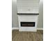 Modern fireplace with wood mantel and electric firebox set against shiplap wall at 85 Prestwick Pl, Walterboro, SC 29488