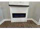 Close up of modern electric fireplace with shiplap accent wall and wood mantle at 85 Prestwick Pl, Walterboro, SC 29488