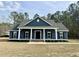 Charming single-story home with dark siding, white trim, shutters, and a welcoming front porch at 85 Prestwick Pl, Walterboro, SC 29488