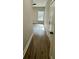 Hallway with wood floor leading to an open doorway with white trim and neutral paint at 85 Prestwick Pl, Walterboro, SC 29488