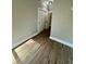 Hallway with wood floor leading to an open doorway with white trim and neutral paint at 85 Prestwick Pl, Walterboro, SC 29488