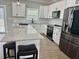 Close-up view of a modern kitchen with white cabinetry, stainless steel appliances, and a large island at 85 Prestwick Pl, Walterboro, SC 29488