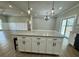 Bright, modern kitchen featuring a large island with stone countertops and stylish pendant lighting at 85 Prestwick Pl, Walterboro, SC 29488