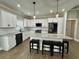 Bright and spacious kitchen with white cabinets, stainless steel appliances, a large island, and pendant lights at 85 Prestwick Pl, Walterboro, SC 29488